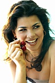 Young woman eating cherries