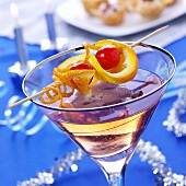 Cocktail with champagne and skewered fruit for Christmas