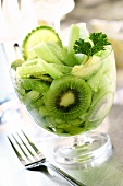 Green salad of kiwi fruits, cucumber and avocados