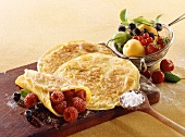 Pancakes with raspberries; fresh fruit in sieve