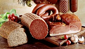 Various types of sausages, bread and radishes