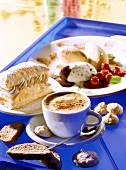 Cup of cappuccino, sweet biscuit and mousse