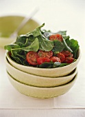 Spinach salad with cherry tomatoes and pesto