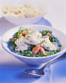 Redfish stew with peas and carrots; rice