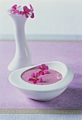 Raspberry yoghurt with edible flowers