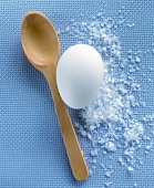 Still life with egg, salt and wooden spoon