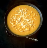 Bean and pumpkin soup with grated cheese