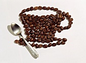 Coffee cup shape in coffee beans with spoon