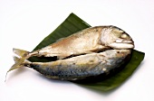 Steamed saltwater fish on banana leaf