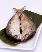 Steamed saltwater fish on banana leaf