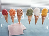 Cones of different coloured ice creams in cone holder