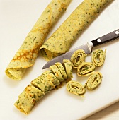 Cutting herb pancakes into strips