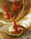 King prawn with avocado cream on slice of lime
