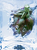 Artichoke in glass container of boiling water