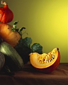 A piece of pumpkin, various pumpkins in background