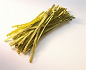 Green ribbon noodles on light background