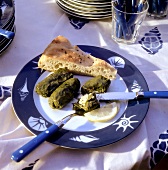 Stuffed vine leaves with flat bread on plate