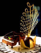 Cake decorated with a chocolate piano & ball with caramel threads