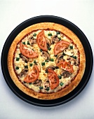 Pizza with mushrooms and tomatoes on pizza plate