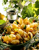 Pasta salad with melon balls, bacon and pine nuts