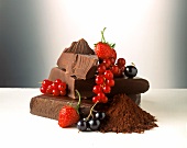 Still life with chocolate, cocoa powder and berries