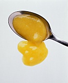 Mango sauce running from a spoon