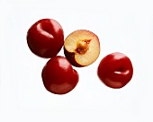 Three red plums and half a plum