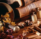 Still life with spices, herbs, mortar and books