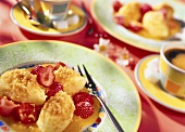 Semolina dumplings with strawberries and mango sauce