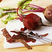 Peeling cooked beetroot with a vegetable peeler