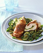 Chicken breast with pesto and Parma ham on courgettes