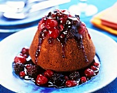 English chocolate pudding with red stewed fruit