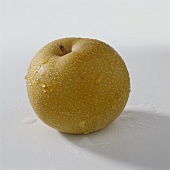 A nashi fruit with drops of water