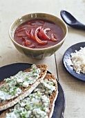 Onion soup, slices of bread with herb quark in front