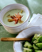 Creamy romanesco soup with tomatoes and garlic