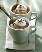Cappuccino mousse with cream topping and cocoa in cup