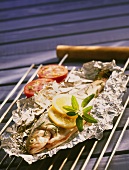 Trout on aluminium foil before grilling