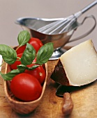 Fresh tomatoes, basil and piece of cheese; sauce-boat