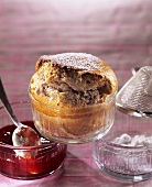 Soufflé with strawberry jam in glass baking dish
