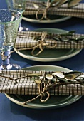 Mediterranean place settings with green plates & olive branches