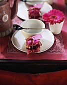 Asian place setting with white crockery and red decorations