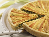 Hearty Easter quiche with carrots & spinach, a slice cut