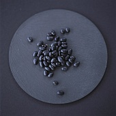 Black beans on grey background