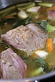 Stewing meat with vegetables cooking in pan