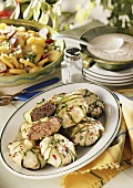 Burgers wrapped in courgette with potato salad