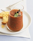 Spicy tomato soup with capers in glass