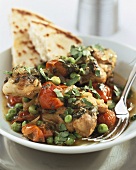 Chicken with tomatoes, peas, coriander leaves and flatbread