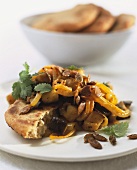 Aubergine ragout with pumpkin seeds and flatbread (India)