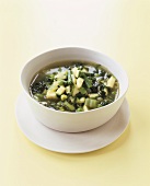 Green vegetable soup in white soup bowl
