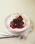 Piece of berry and cherry tart with cream